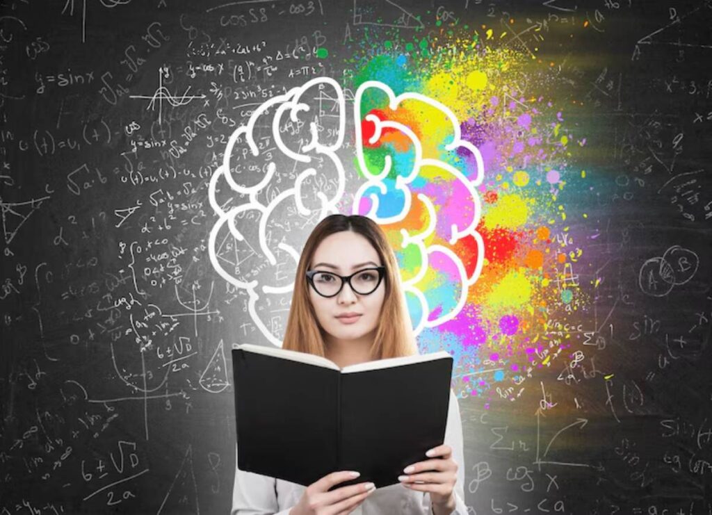 A person reading a book in front of a chalkboard filled with mathematical equations and a colorful brain illustration above.