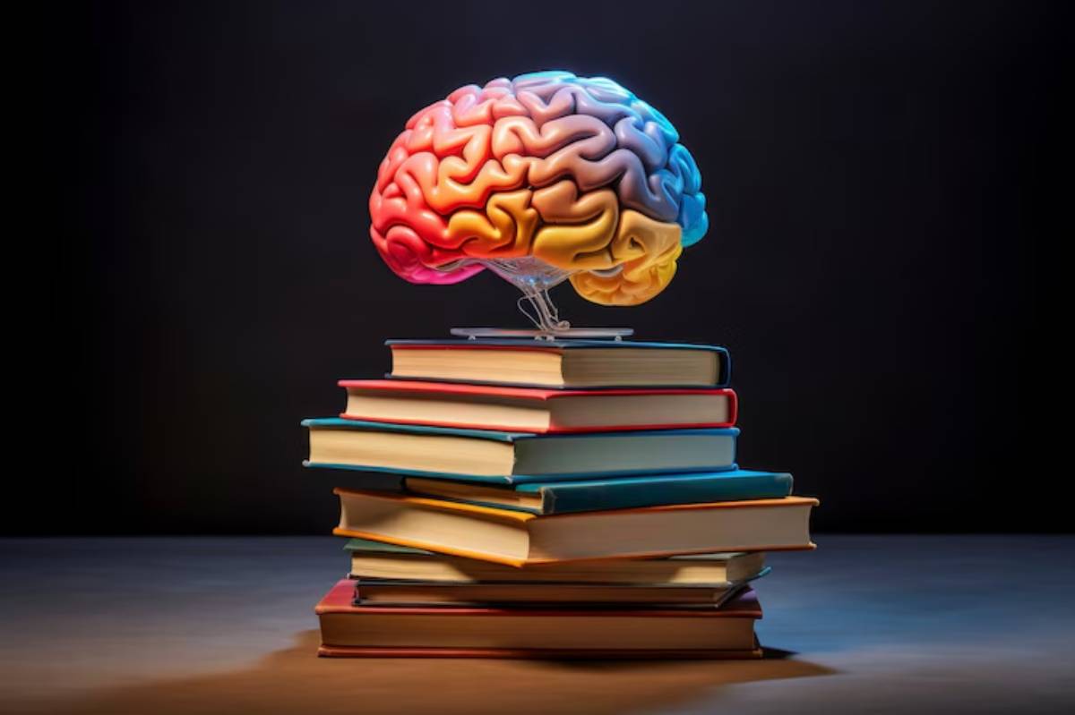 A colorful brain floats above a stacked collection of books, symbolizing knowledge and intellect against a dark background.