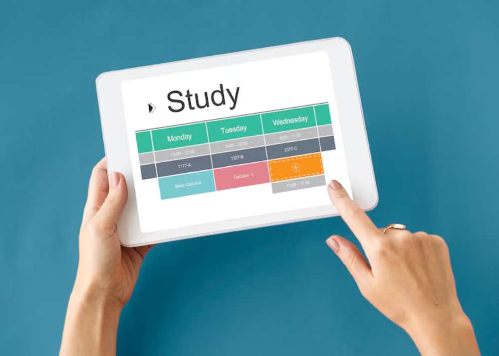 A person holding a tablet displaying a weekly study schedule with highlighted class timings for Monday, Tuesday, and Wednesday.